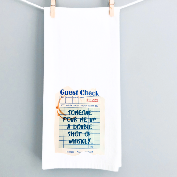 kitchen towel with a guest check design in blue, a shot glass ring and the words, someone pour me up a double shot of whiskey