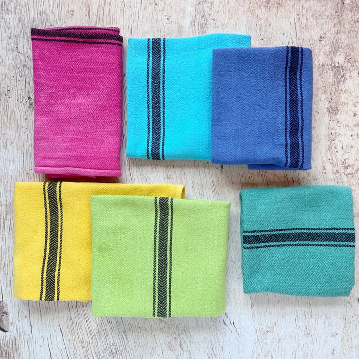 hand-dyed kitchen towels with herringbone flat weave pattern, in colors of yellow gold, lime green, blueberry, gumdrop pink, aqua velvet green and pool side teal. use as napkins, towels or placemats.