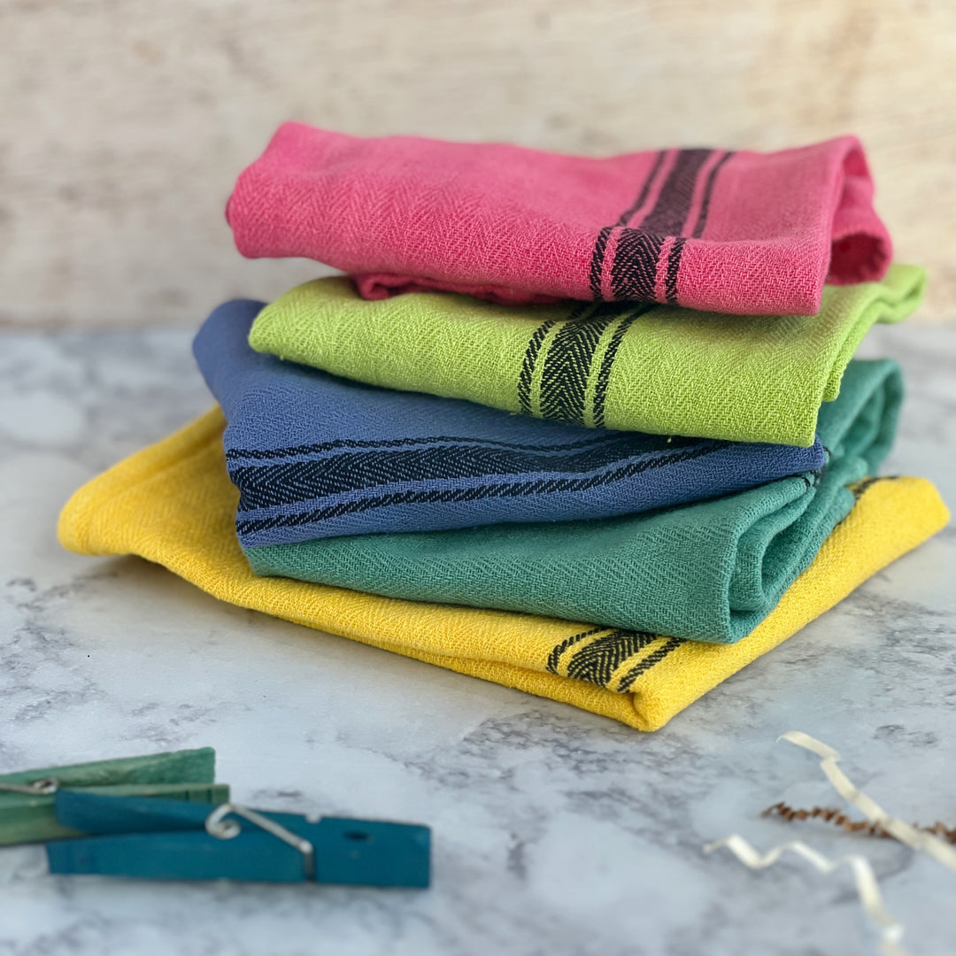 hand-dyed kitchen towels with herringbone flat weave pattern, in colors of yellow gold, lime green, blueberry, gumdrop pink, aqua velvet green and pool side teal. use as napkins, towels or placemats.