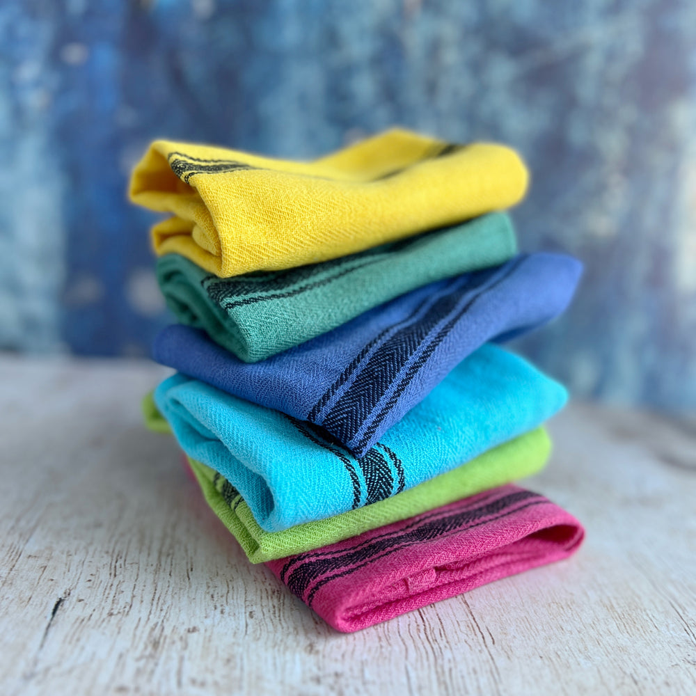 hand-dyed kitchen towels with herringbone flat weave pattern, in colors of yellow gold, lime green, blueberry, gumdrop pink, aqua velvet green and pool side teal. use as napkins, towels or placemats.