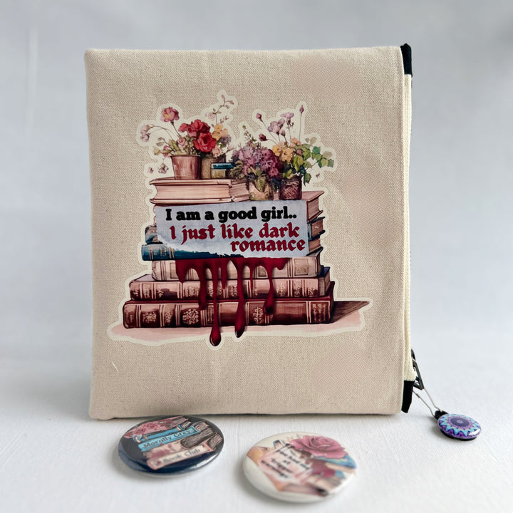 square canvas zip bag with lining and a design of stacked books, flowers, and the words, "I am a good girl..I just like dark romance."