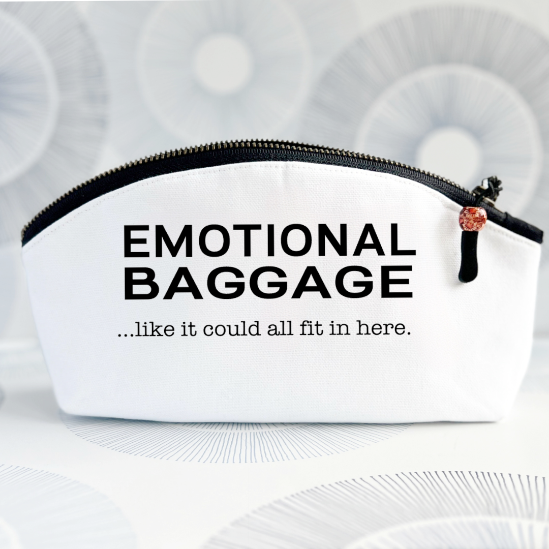 a white canvas zip bag with a curvy top, black zipper and the words, emotional baggage...like it could all fit in here.