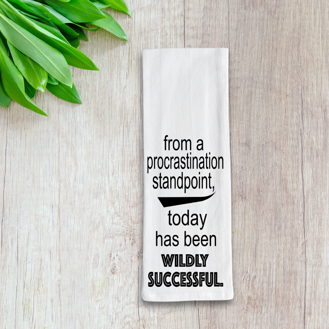 white rectangular kitchen towel with the words, from a procrastination standpoint, today has been wildly successful.