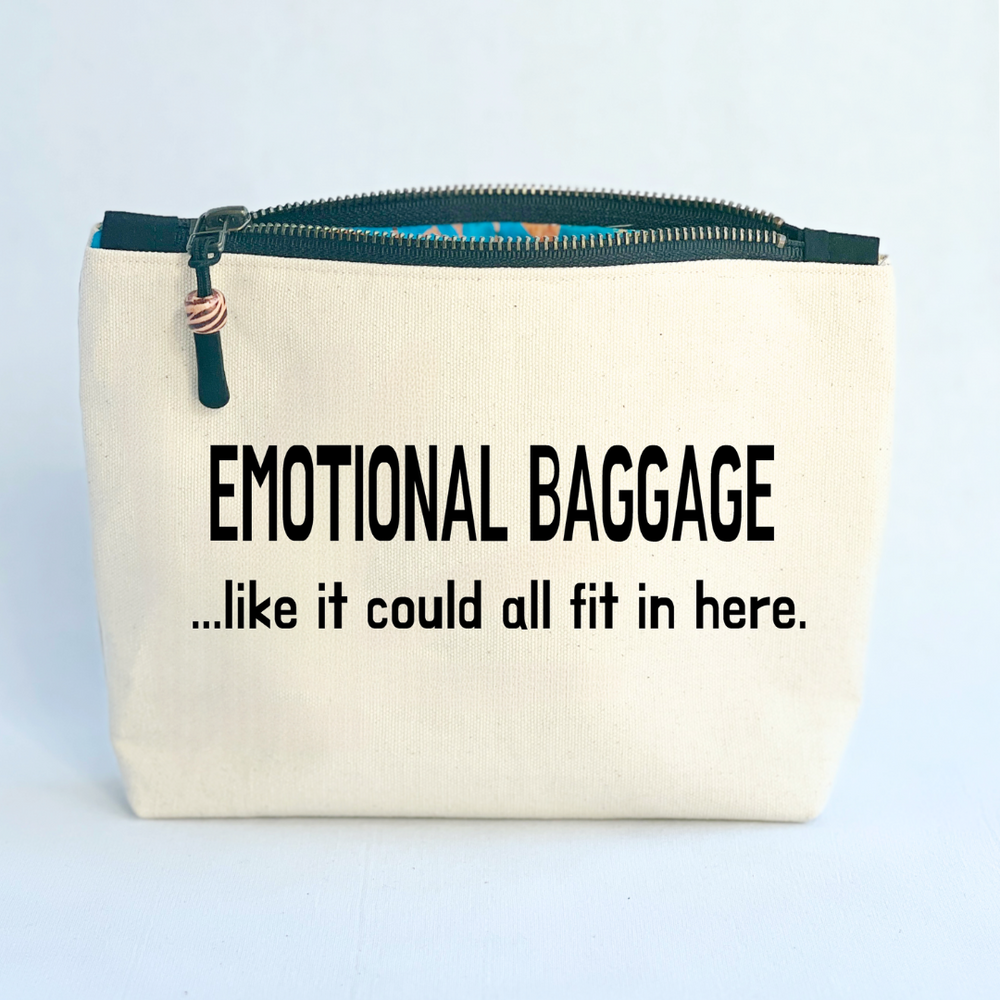 square linen-color canvas zip bag with black zipper and the words, emotional baggage...like it could all fit in here.