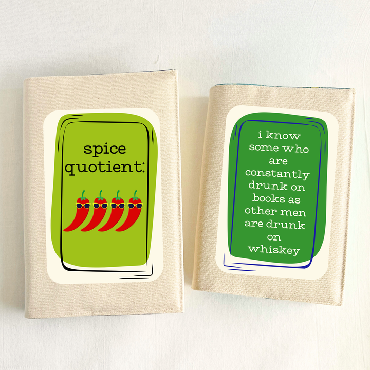 a book covered in linen-color reusable canvas adjustable book cover. A bright green square is the background for the words, 'spice quotient' in black lettering. Four cartoon peppers with sunglasses are layered on top. A second book has a dark green square with white letters saying, 'I know some who are constantly drunk on books as other men are drunk on whiskey.'