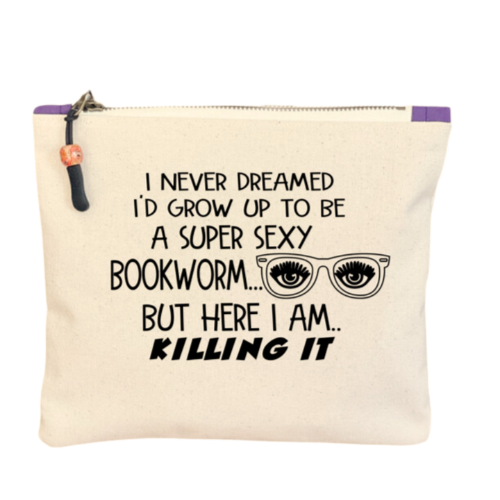 9x7 inch canvas bag with a zipper pull, watercolor paint swashes and the words, "I never dreamed I'd grow up to be a super sexy bookworm..but here I am..killing it."