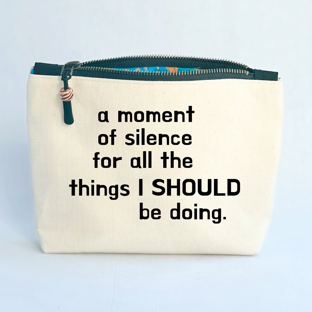 a square linen-color canvas zip bag with a black zipper and the words, a moment of silence for all the things I SHOULD be doing.