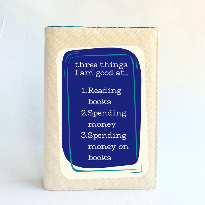 canvas book cover with a purple square and the words, three things I am good at - reading books, spending money, spending money on books.