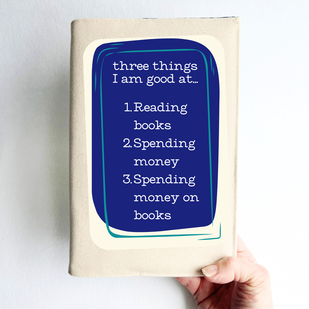 canvas book cover with a purple square and the words, three things I am good at - reading books, spending money, spending money on books.