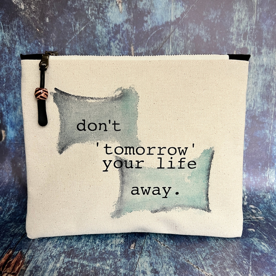 square canvas zip bag with the words, don't 'tomorrow' your life away