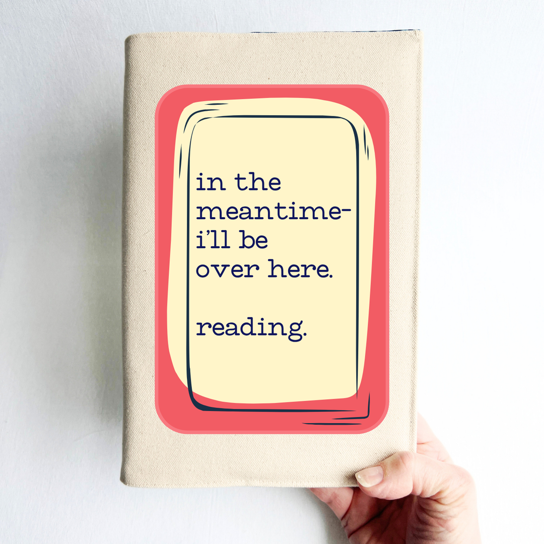a hand holding a rectangular linen-colored canvas book cover with a rose graphic topped by a cream square and the words, 'in the meantime, I'll be over here reading.
