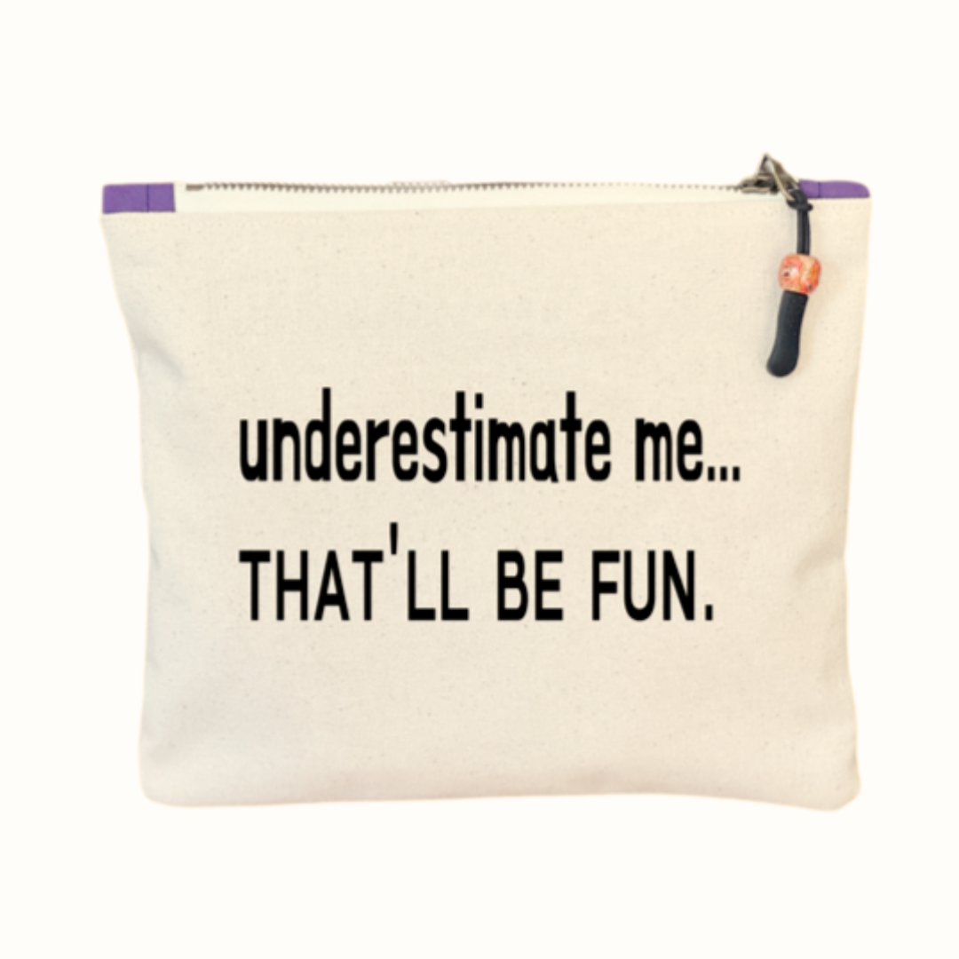 a canvas zip bag with the words, "underestimate me, that'll be fun" in black lettering