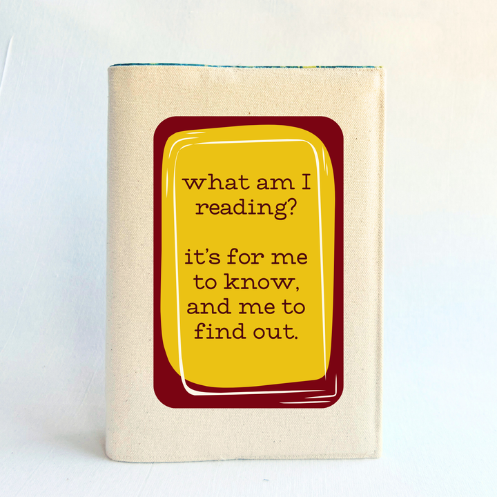 A rectangular linen-colored canvas book cover with a deep red graphic topped with a yellow rectangle and the words, 'what am i reading? it's for me to know, and me to find out' in deep red
