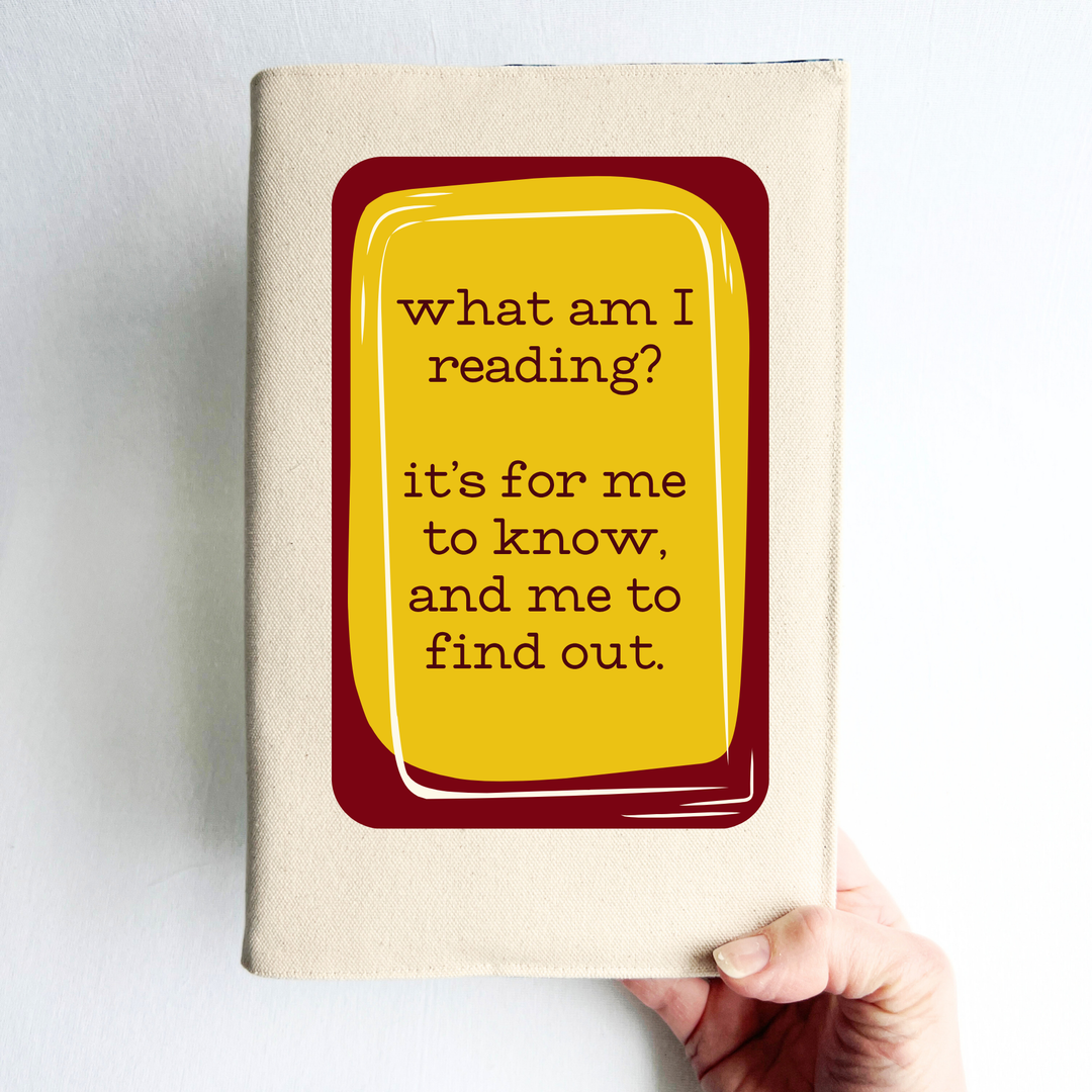 A rectangular linen-colored canvas book cover with a deep red graphic topped with a yellow rectangle and the words, 'what am i reading? it's for me to know, and me to find out' in deep red