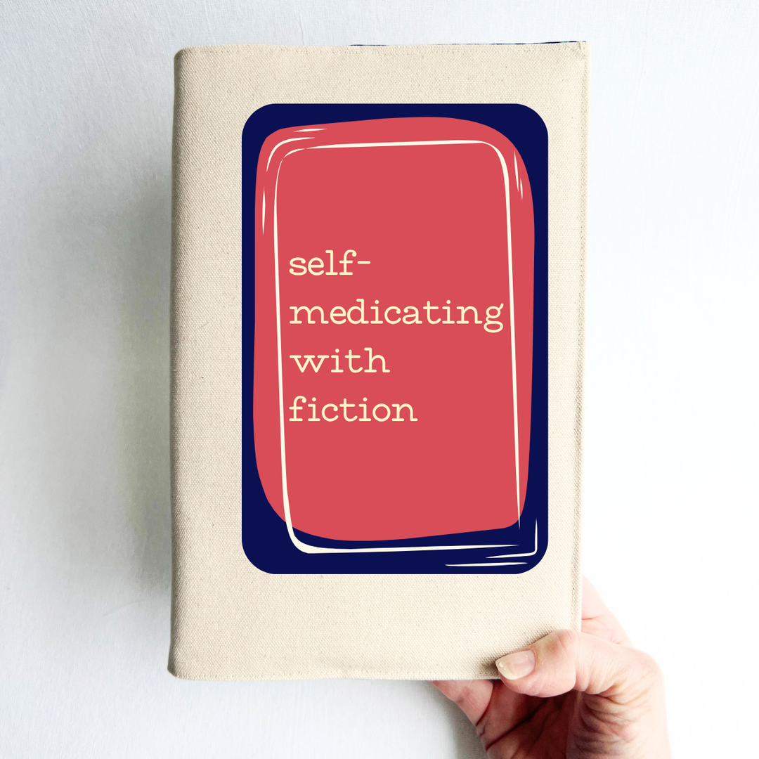 a hand holding a rectangular linen-colored canvas book cover with a navy graphic topped by a rose square and the words, 'self-medicating with fiction' in white lettering