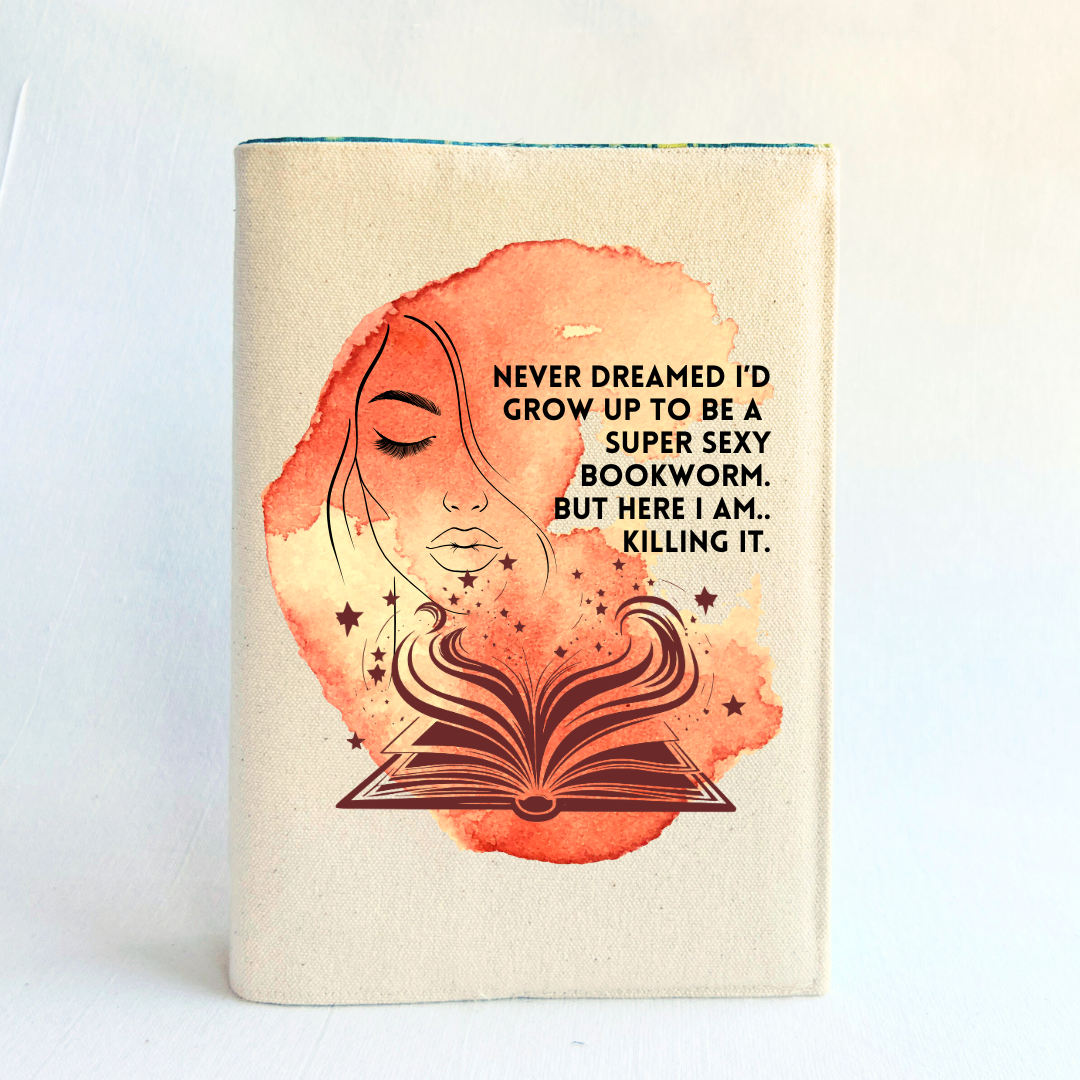 a book covered with a linen-colored canvas with a vibrant orange-yellow watercolor swash, featuring the outline of a face with long lashes and lush lips, an open book with stars and flourishes, and the words, 'never dreamed I'd grow up to be a super sexy bookworm. but here I am, killing it.' 