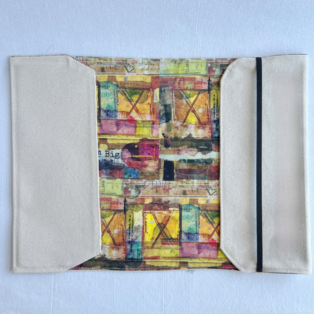 the inside lining of a reusable book cover, with duck canvas on the outside, and a colorful fabric on the inside. 