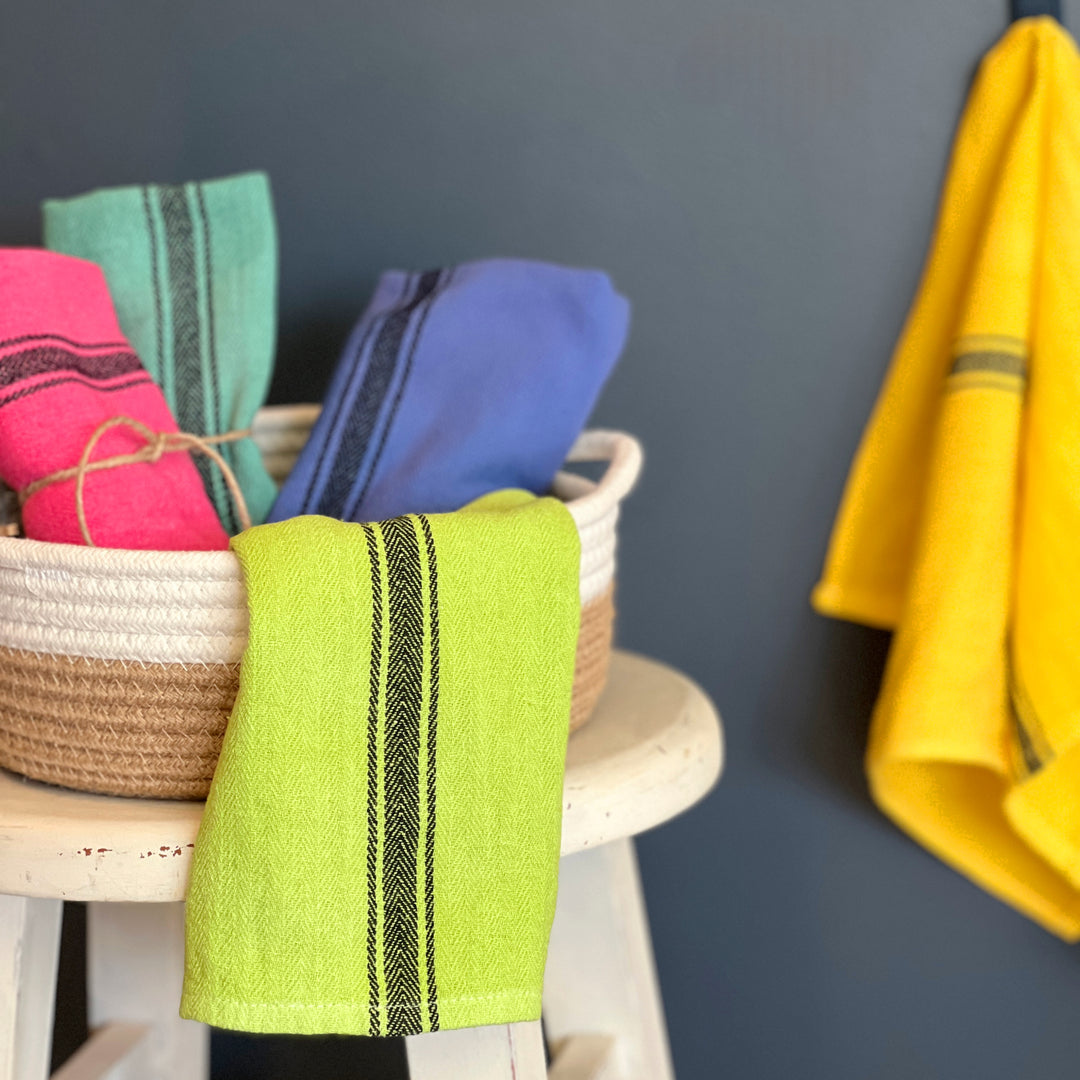 hand-dyed kitchen towels with herringbone flat weave pattern, in colors of yellow gold, lime green, blueberry, gumdrop pink, aqua velvet green and pool side teal. use as napkins, towels or placemats.