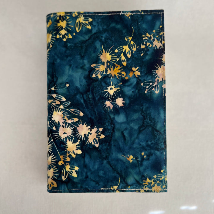 rectangular book cover made of lush batik fabric in deep blues, with yellow starflower bursts of color