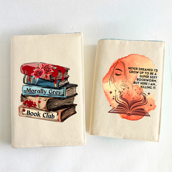 a book covered with a linen-colored canvas reusable book cover with a vibrant orange-yellow watercolor swash, featuring the outline of a face with long lashes and lush lips, an open book with stars and flourishes, and the words, 'never dreamed I'd grow up to be a super sexy bookworm. but here I am, killing it.'  A second book with a canvas cover and the design of a book stack with roses, blood drips and splatters and the words, 'Morally grey book club' are displayed as a combo purchase.