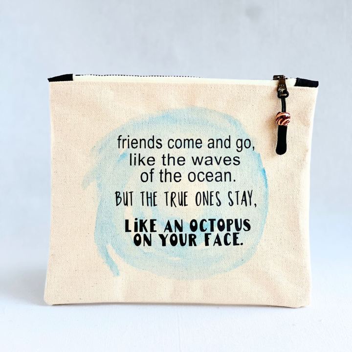9x7 inch canvas bag with zipper pull, with a blue watercolor swash and the words, "friends come and go, like the waves of the ocean. But the true ones stay, like an octopus on your face."