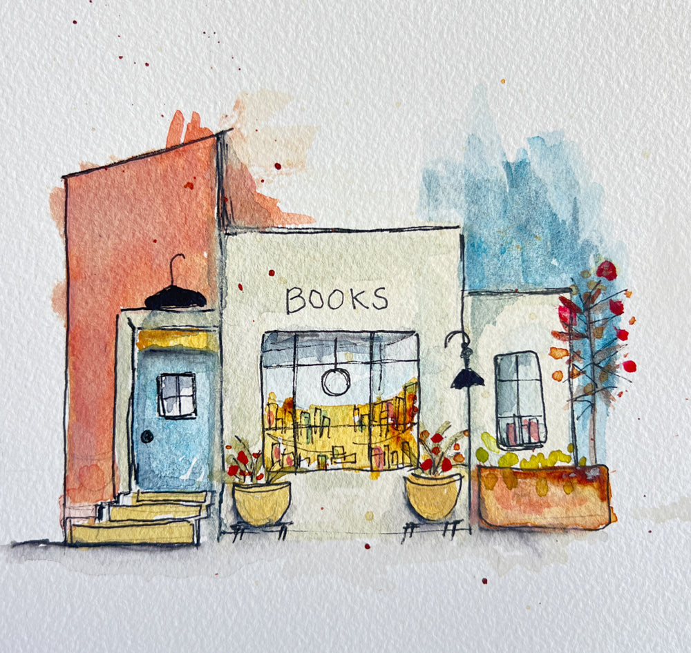 Watercolor painting of a quaint bookstore storefront with the word 'BOOKS' written above the window. The illustration features a coral-pink building section on the left, a light blue door, yellow planters with red flowers, and a blue watercolor sky on the right, all on a textured white paper background.