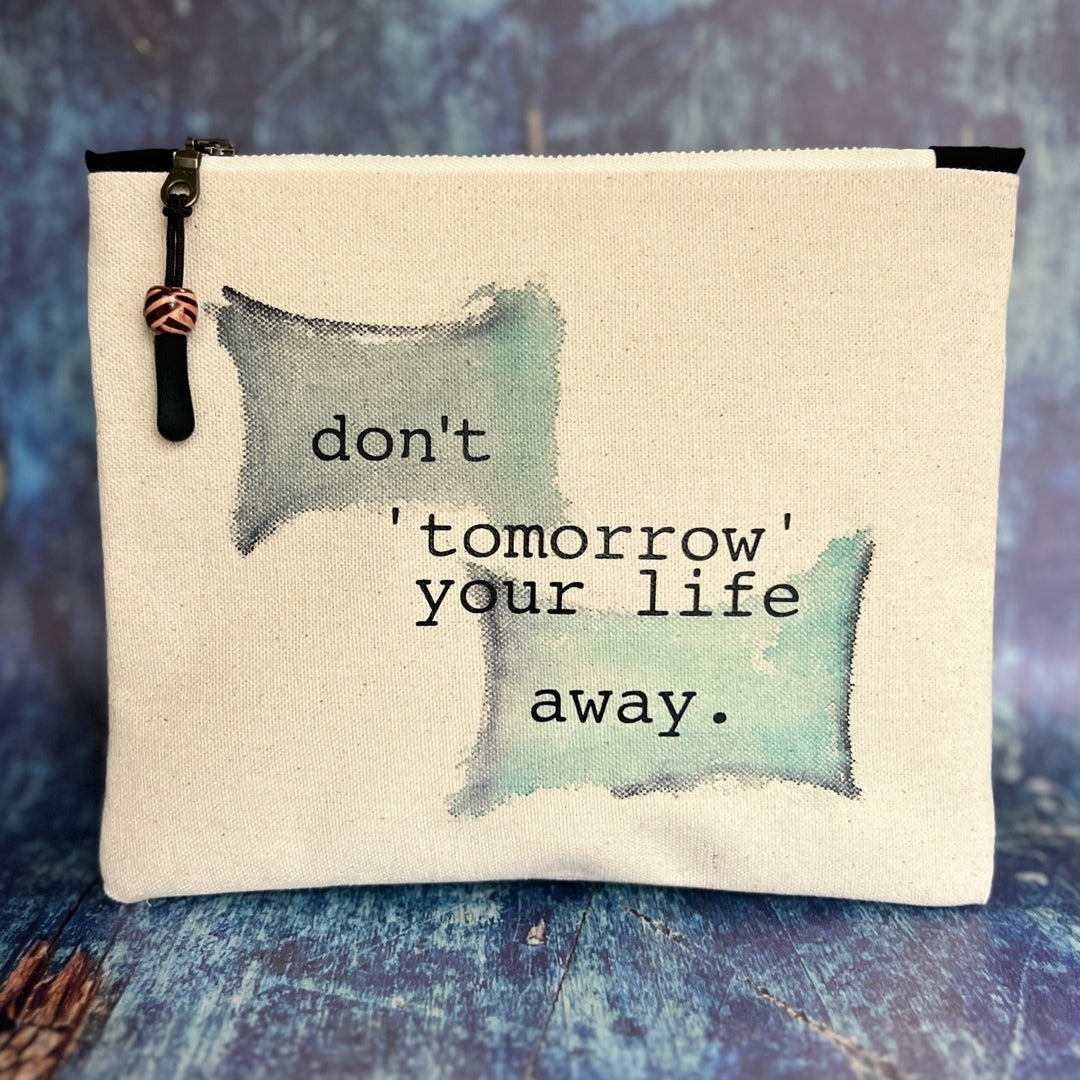 square canvas zip bag with the words, don't 'tomorrow' your life away