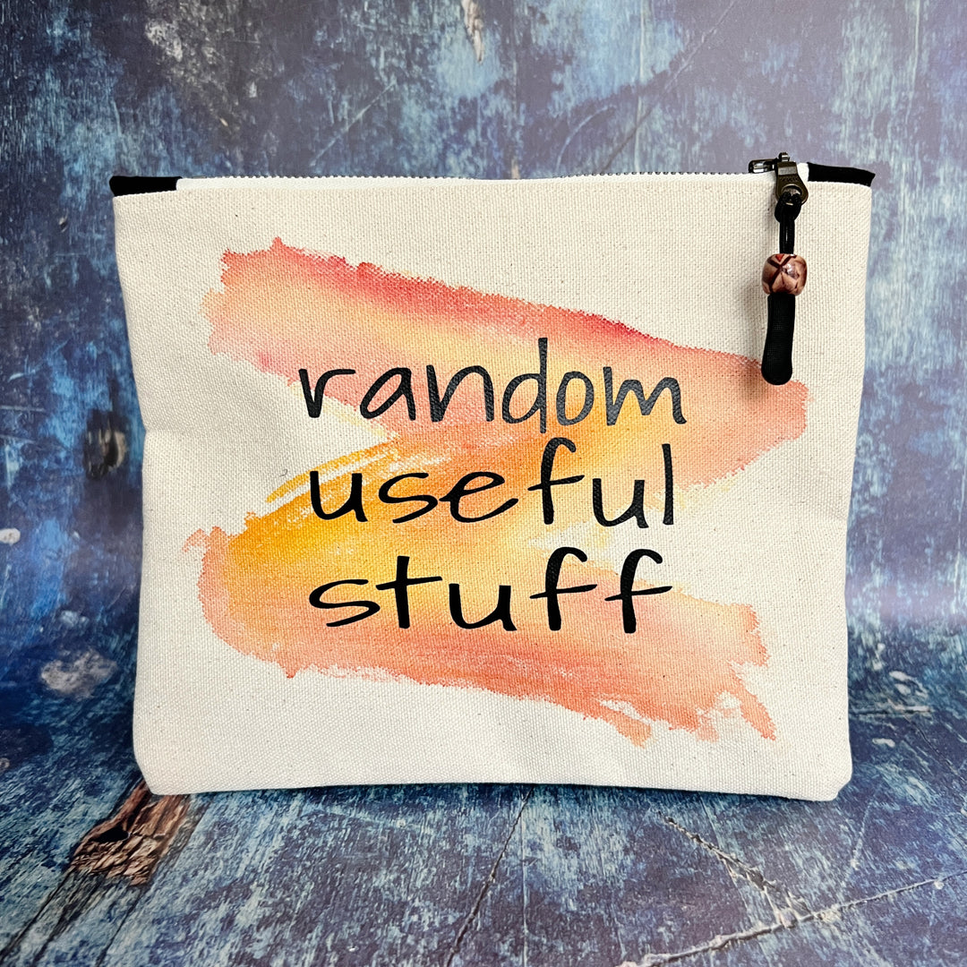 square canvas zipper pull bag with the words, random useful stuff