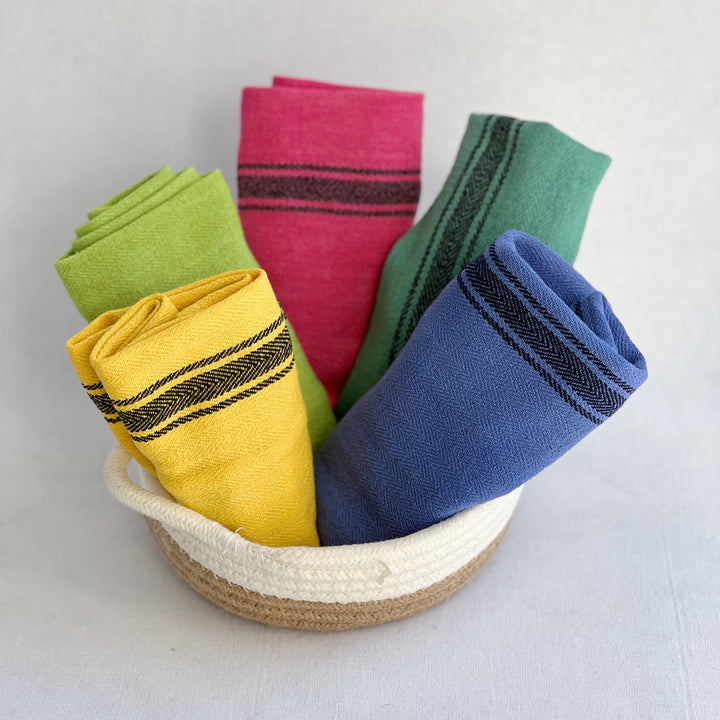 hand-dyed kitchen towels with herringbone flat weave pattern, in colors of yellow gold, lime green, blueberry, gumdrop pink, aqua velvet green and pool side teal. use as napkins, towels or placemats.