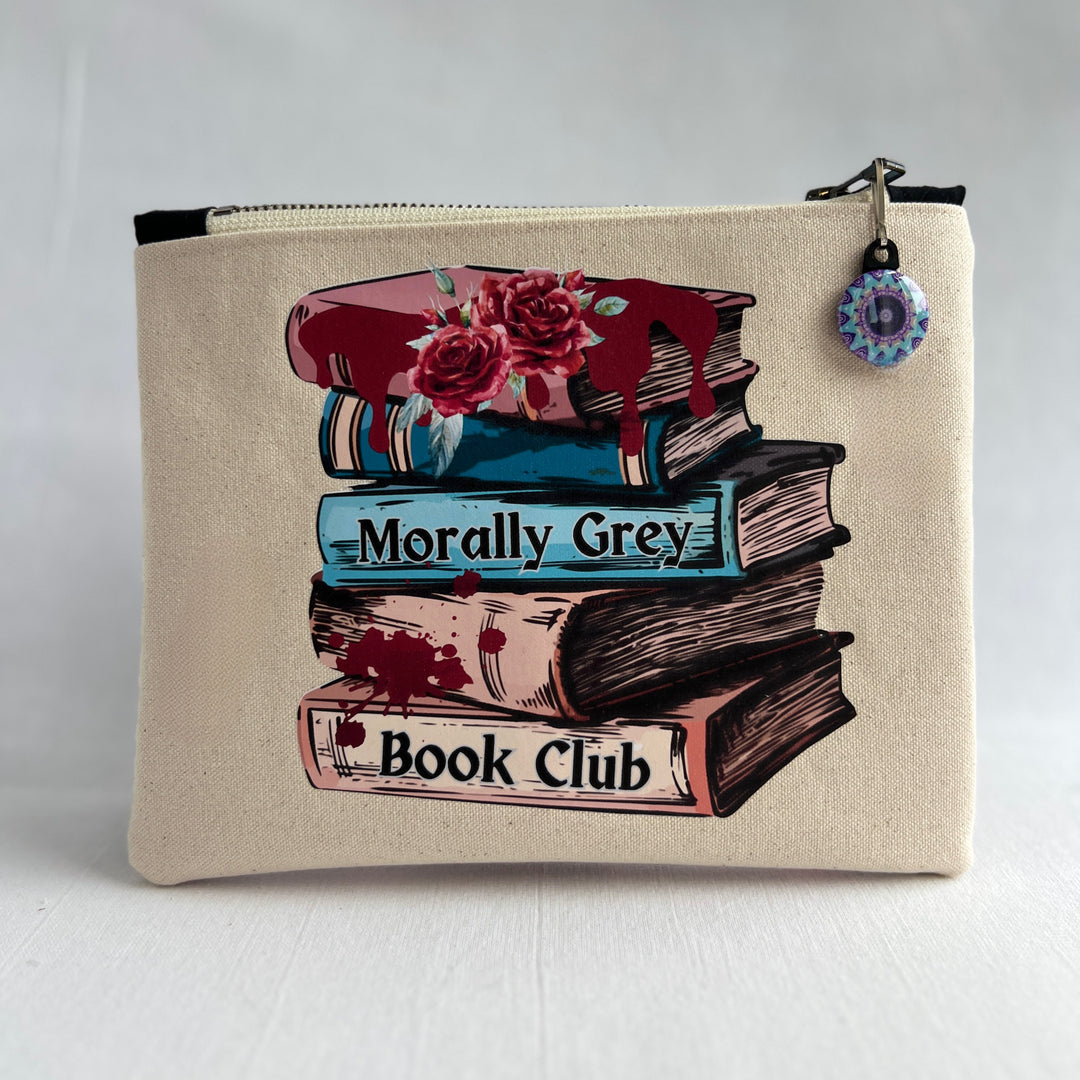 square canvas bag with colorful zipper pull, and a design on the front with a stack of books, some roses, blood spatters and drips and the words, "Morally grey book club."
