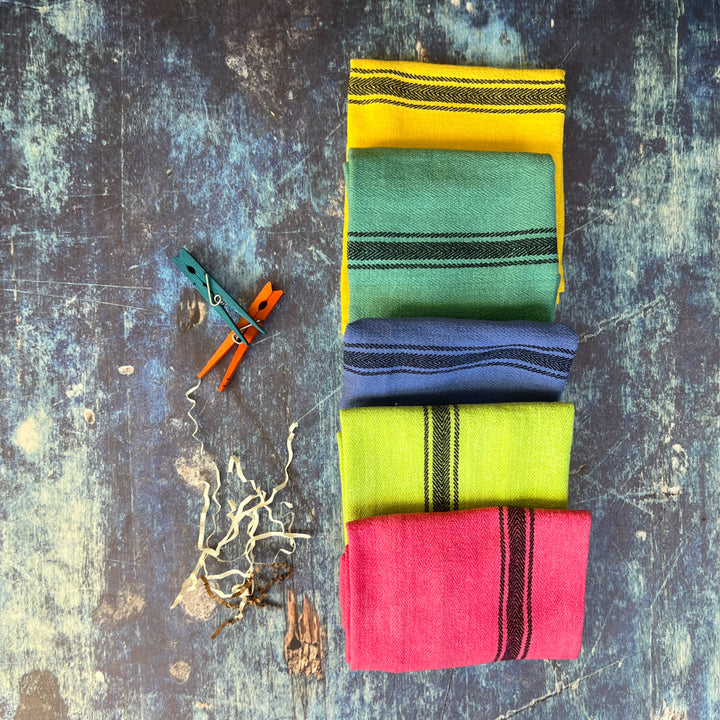hand-dyed kitchen towels with herringbone flat weave pattern, in colors of yellow gold, lime green, blueberry, gumdrop pink, aqua velvet green and pool side teal. use as napkins, towels or placemats.
