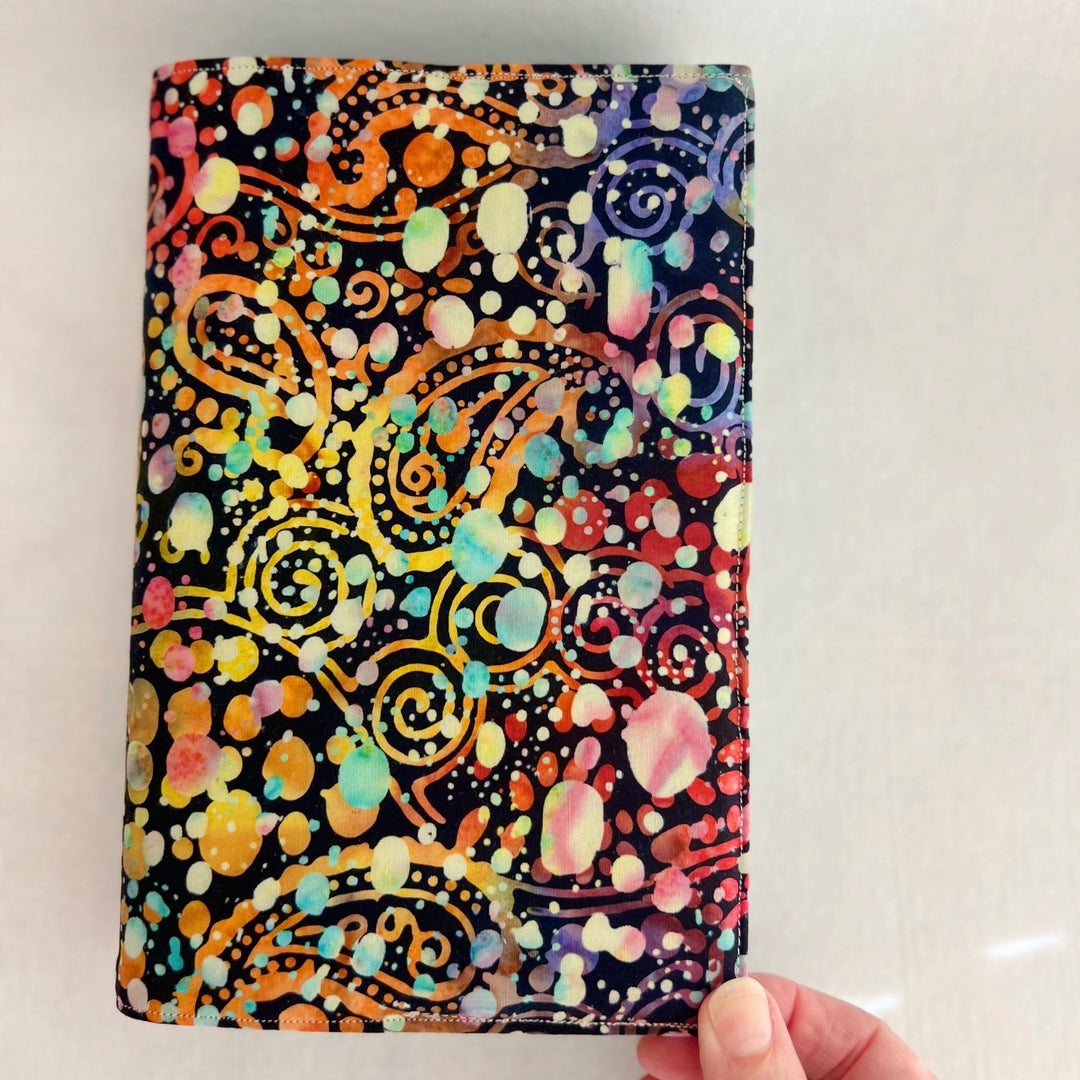 rectangular fabric book cover with rich paisley multicolored splatters and colors