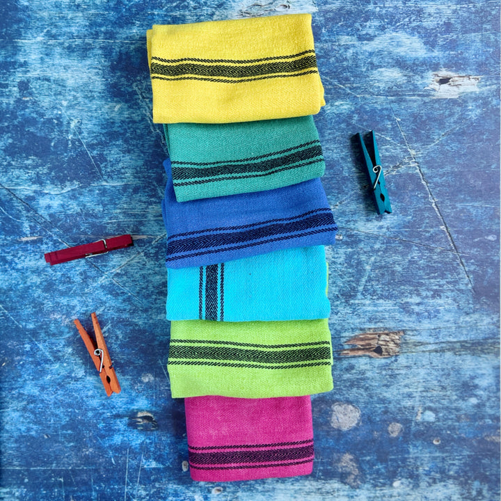 hand-dyed kitchen towels with herringbone flat weave pattern, in colors of yellow gold, lime green, blueberry, gumdrop pink, aqua velvet green and pool side teal. use as napkins, towels or placemats.