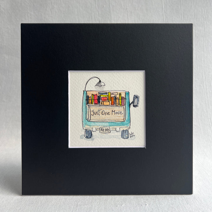 A square original watercolor art print depicting the back end of a blue pickup truck loaded with colorful books and a wonky reading light, with the words, "Just One More' and a license plate with the word 'Read'