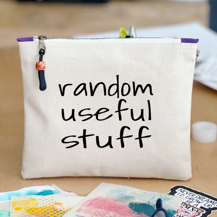 square canvas zipper pull bag with the words, random useful stuff