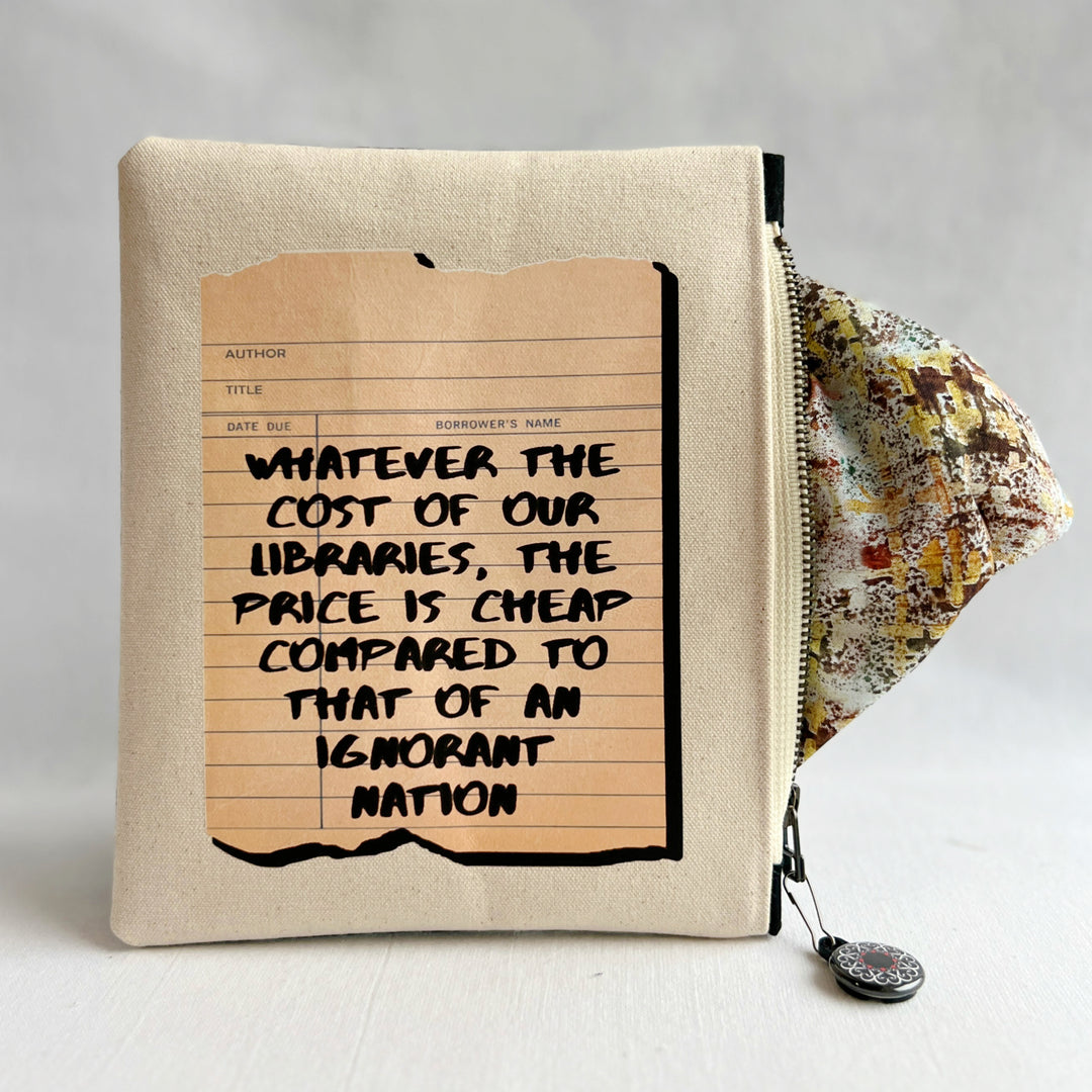 padded canvas zip bag with a linen library card and the words, whatever the cost of our libraries and bookstores, the prices is cheap compared to that of an ignorant nation, plus a colorful zipper pull and lining
