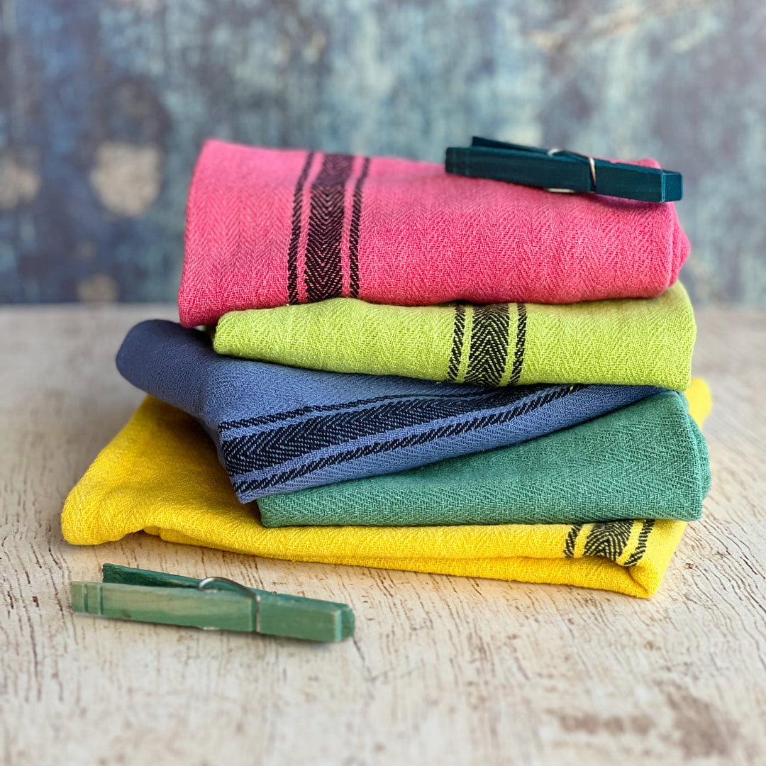 hand-dyed kitchen towels with herringbone flat weave pattern, in colors of yellow gold, lime green, blueberry, gumdrop pink, aqua velvet green and pool side teal. use as napkins, towels or placemats.