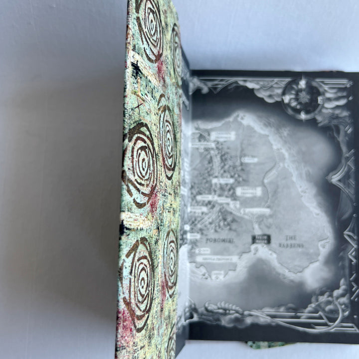 a book covered in a vibrant blue green fabric reusable  adjustable book cover.  Fabric has impressionist rose / concentric deep brown circles and the word ' TRUTH scattered on the pattern.