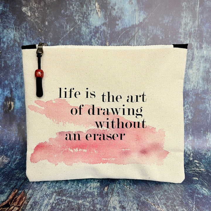 square canvas zipper pull bag with the words, life is the art of drawing without an eraser