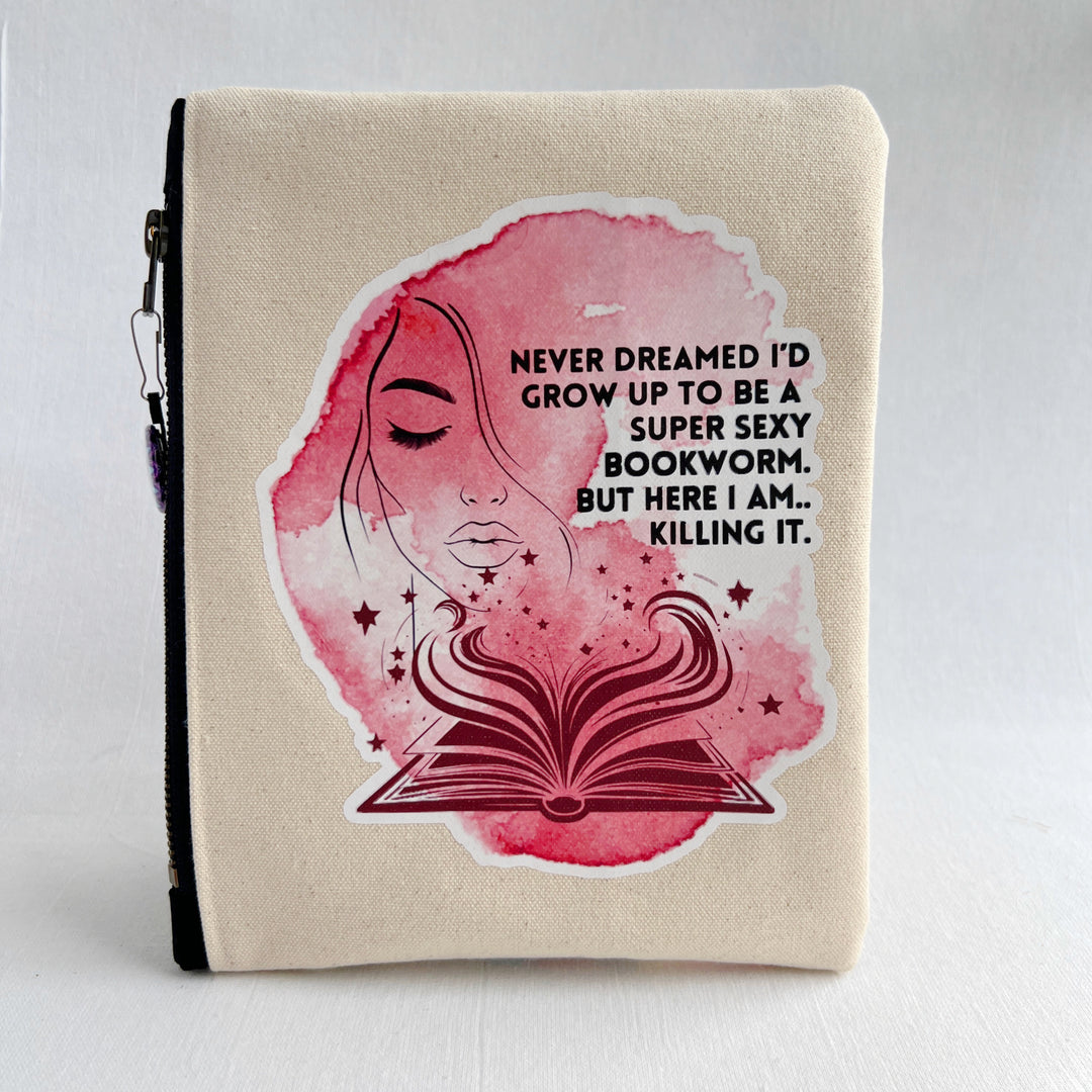 square oblong canvas zipper bag with a design of a face and an open book, with the words, "Never dreamed I'd grow up to be a super sexy bookworm. But here I am..killing it."