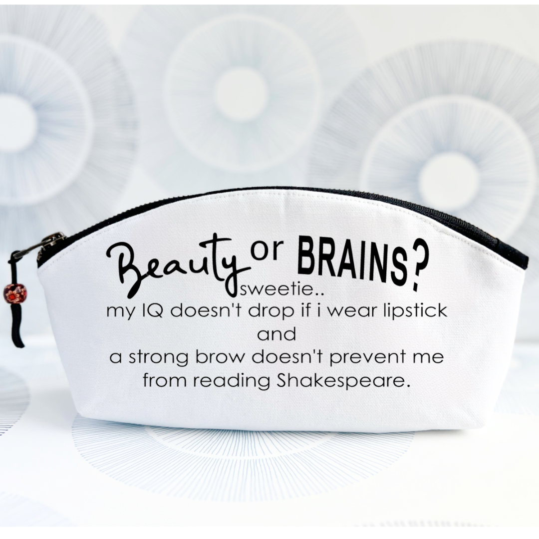 white canvas zip bag with a black zipper and zipper pull, with the words, Beauty or Brains? sweetie, my IQ doesn't drop if I wear lipstick and a strong brow doesn't prevent me from reading Shakespeare.
