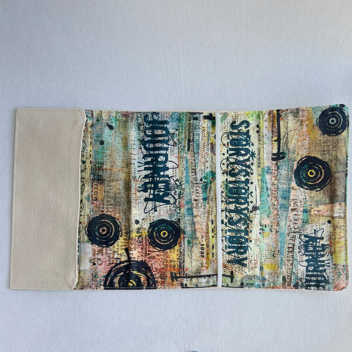 the inside lining of a reusable book cover, with duck canvas on the outside, and a colorful fabric on the inside. 