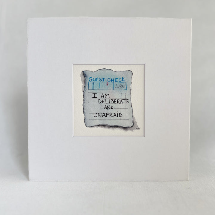 an original watercolor painting in shades of blue-grey, depicting a vintage crumpled diner guest check with the words,I am deliberate and unafraid, matted in white