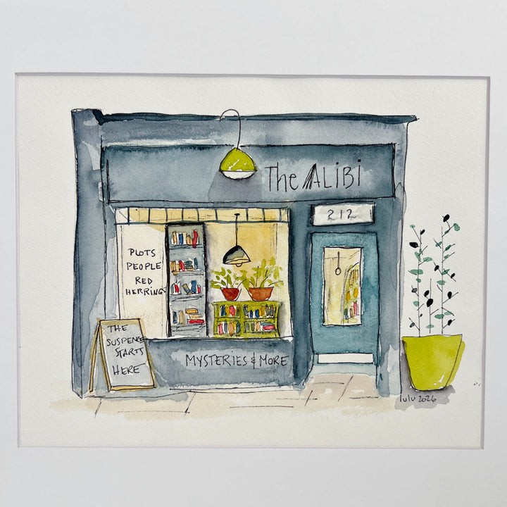 A watercolor art print depicting a cozy bookstore storefront named 'The Alibi', featuring a blue-gray facade, a yellow-green hanging lamp, potted plants, and a chalkboard sign on a white background.