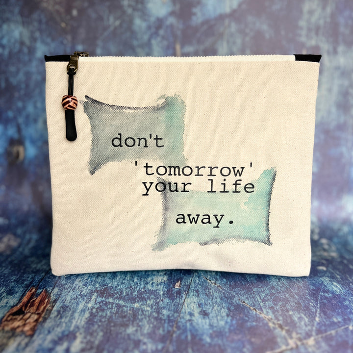 square canvas zip bag with the words, don't 'tomorrow' your life away