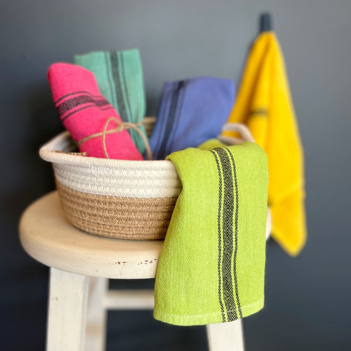hand-dyed kitchen towels with herringbone flat weave pattern, in colors of yellow gold, lime green, blueberry, gumdrop pink, aqua velvet green and pool side teal. use as napkins, towels or placemats.