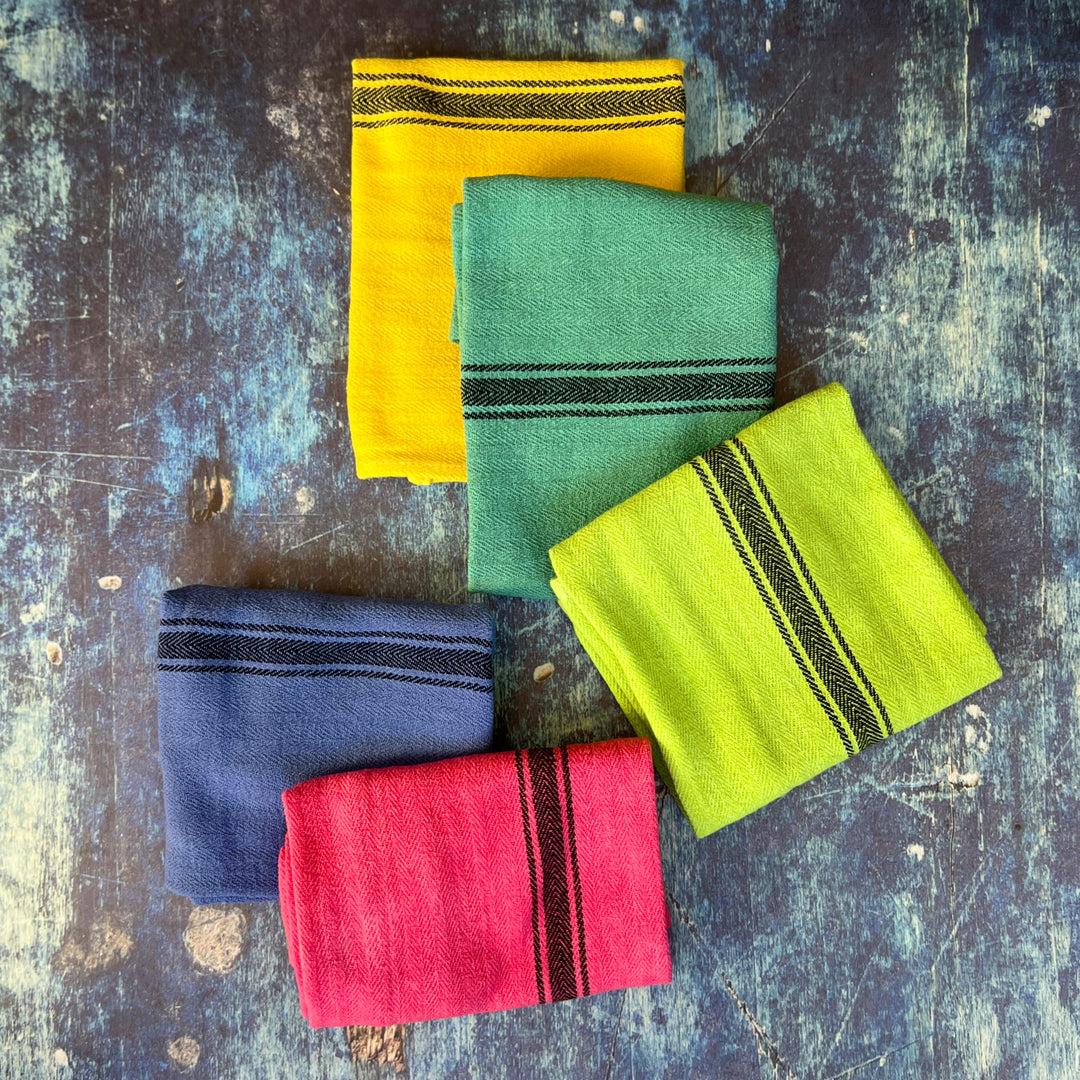hand-dyed kitchen towels with herringbone flat weave pattern, in colors of yellow gold, lime green, blueberry, gumdrop pink, aqua velvet green and pool side teal. use as napkins, towels or placemats.