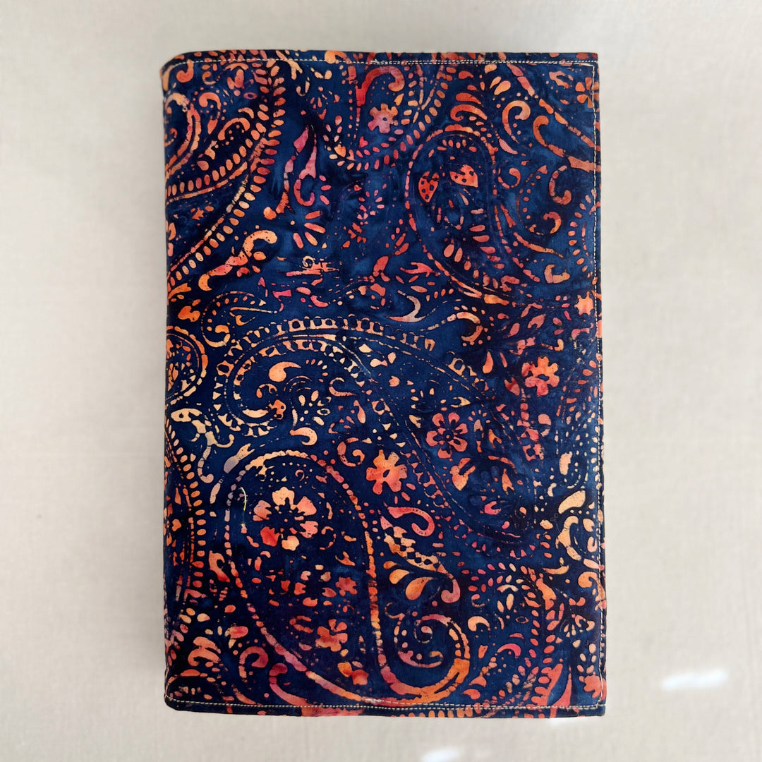 rectangular fabric book cover made of rich orange and yellow paisley on deep navy