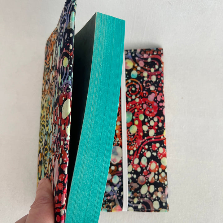 rectangular fabric book cover with rich paisley multicolored splatters and colors