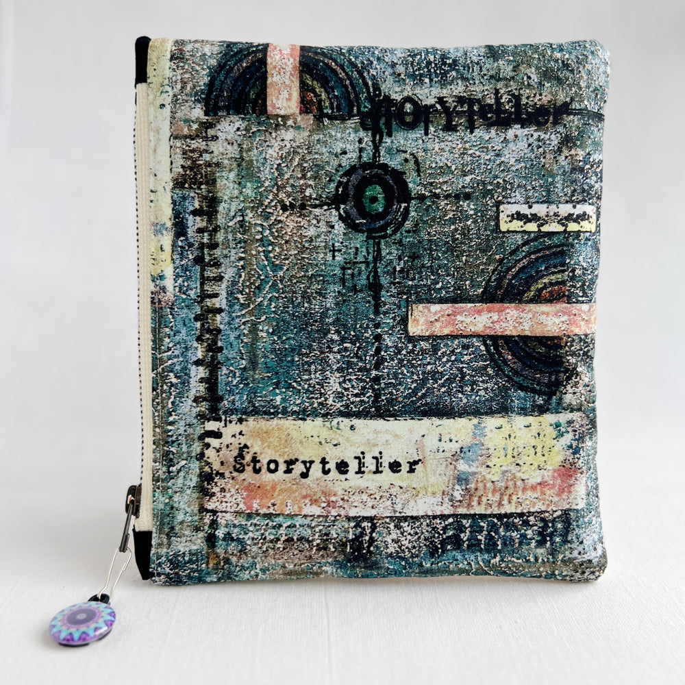 square canvas zip bag with fabric back of blue colors and the word, "storyteller."